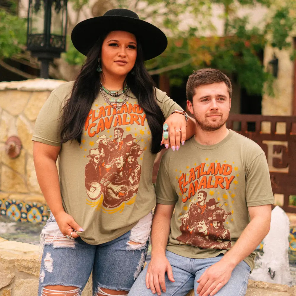 A couple wearing matching t-shirts with ’Layland County’ printed on them.