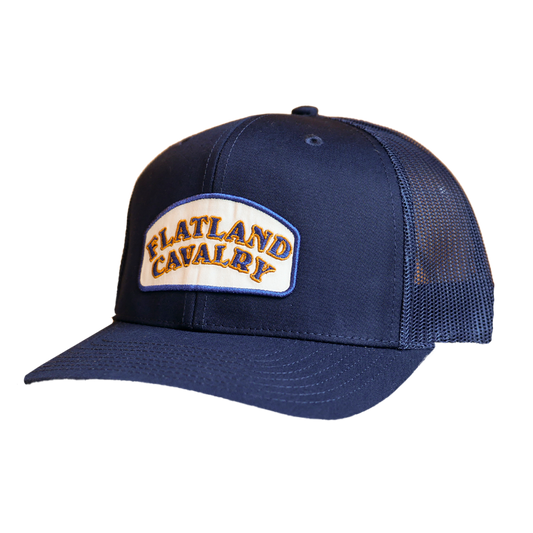Navy blue trucker arched patch hat with cream patch and gold flatland cavalry embroidery flatland cavalry merch