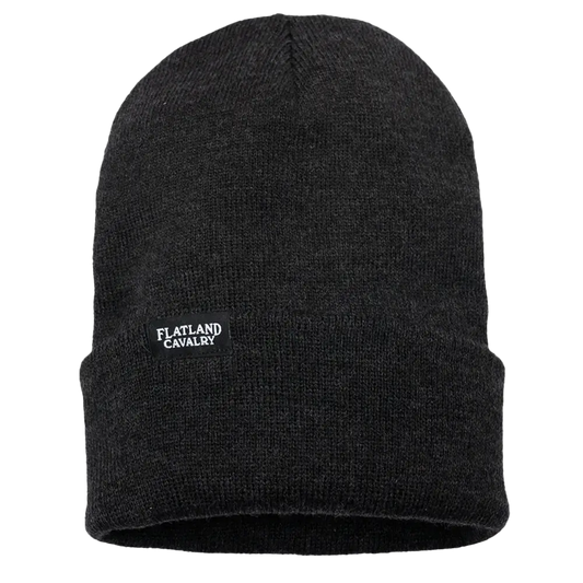 Black knit beanie with a small ’Flatland Cavalry’ logo patch.