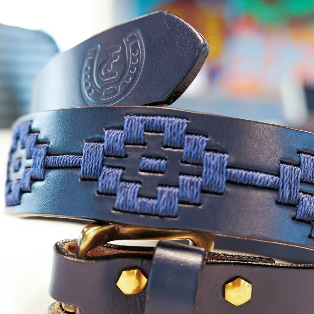 Blue leather belt with stitched pattern.