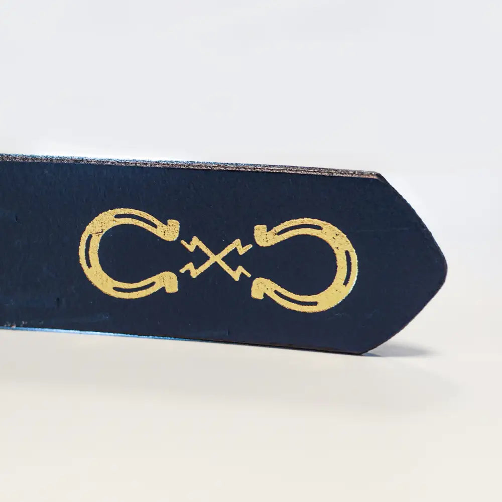 Dark blue belt with gold horseshoe and lightning bolt design.