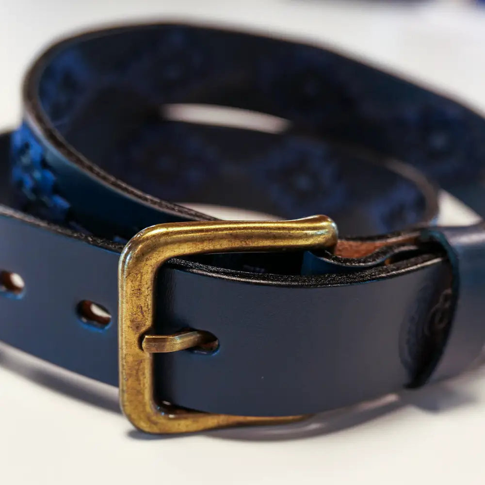 Blue leather belt with brass buckle.