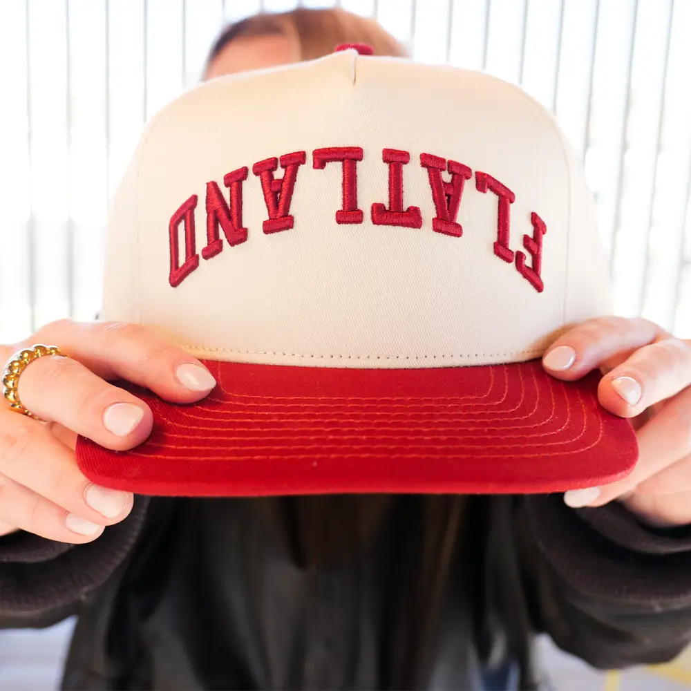 Red and cream ’FLATLAND’ baseball cap.