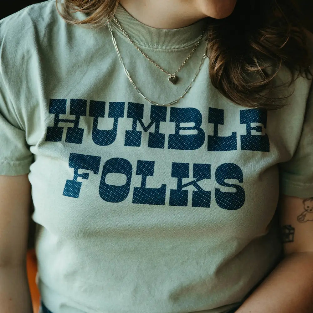 Green t-shirt with ’Humble Folks’ text.