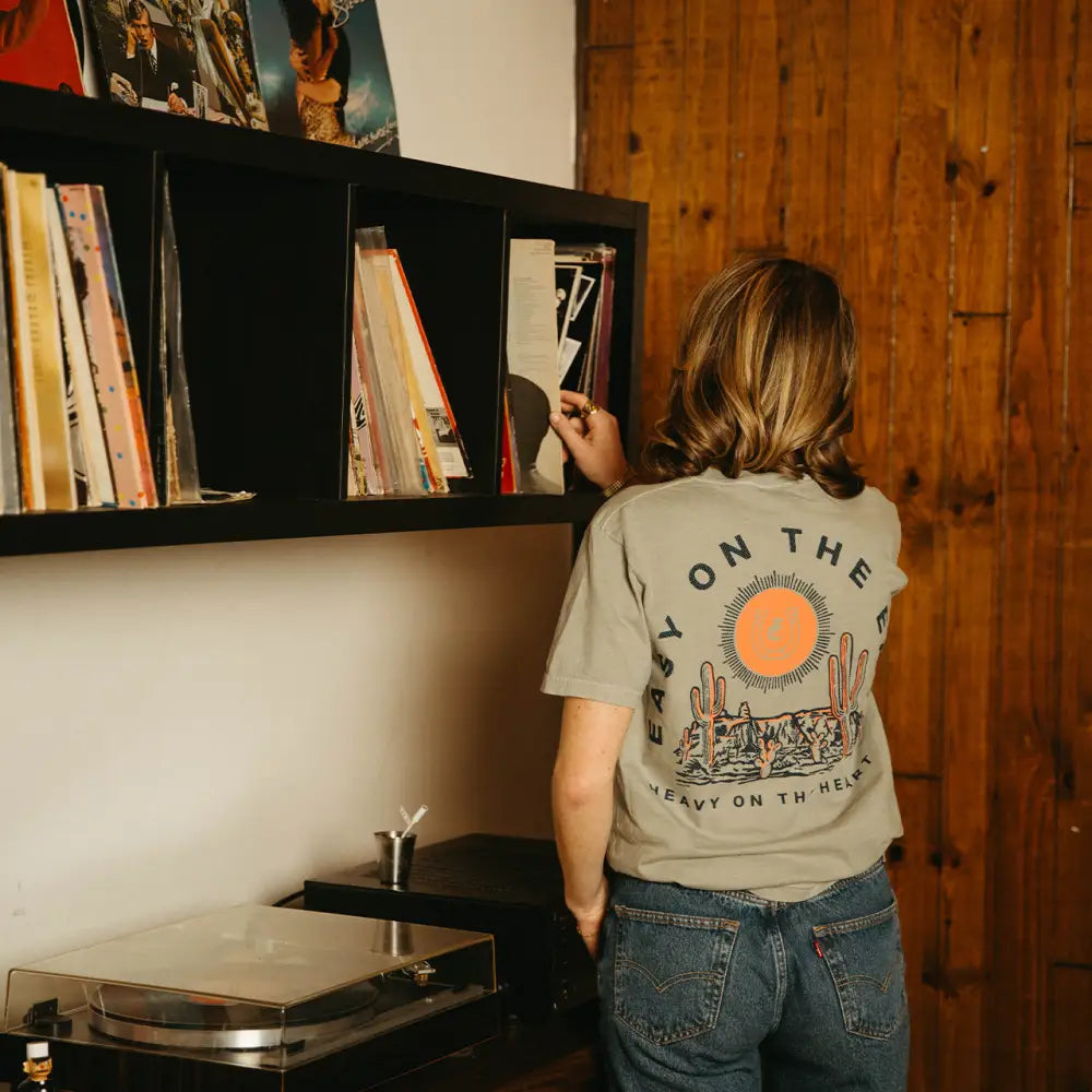 Person selecting vinyl record.