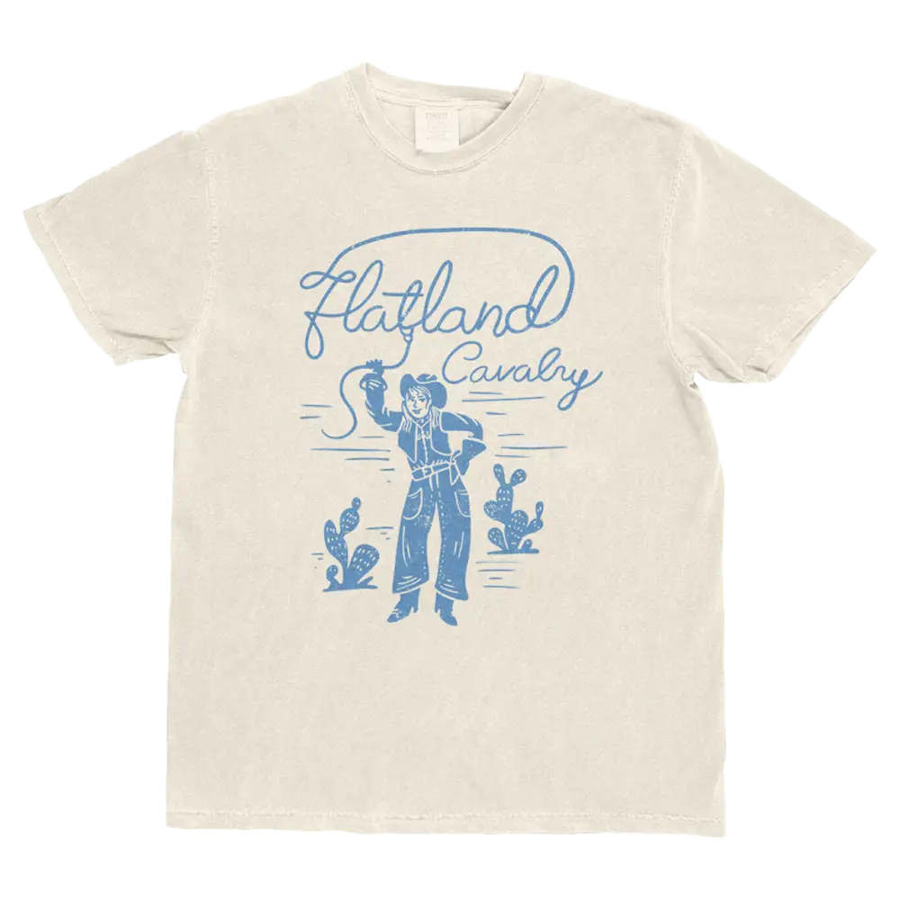 Beige t-shirt with blue graphic design of a cowboy and cacti on a white background