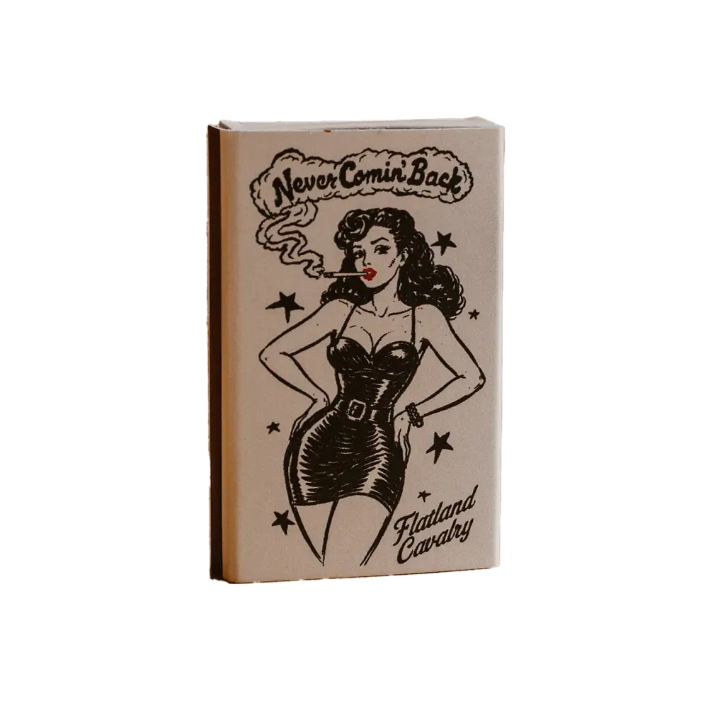 A beige matchbook featuring a black ink illustration of a pin-up woman smoking, with the text ’never comin’ back’ and ’flatland cavalry.’