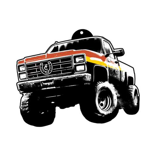 Vintage-style pickup truck with oversized tires and racing stripes.