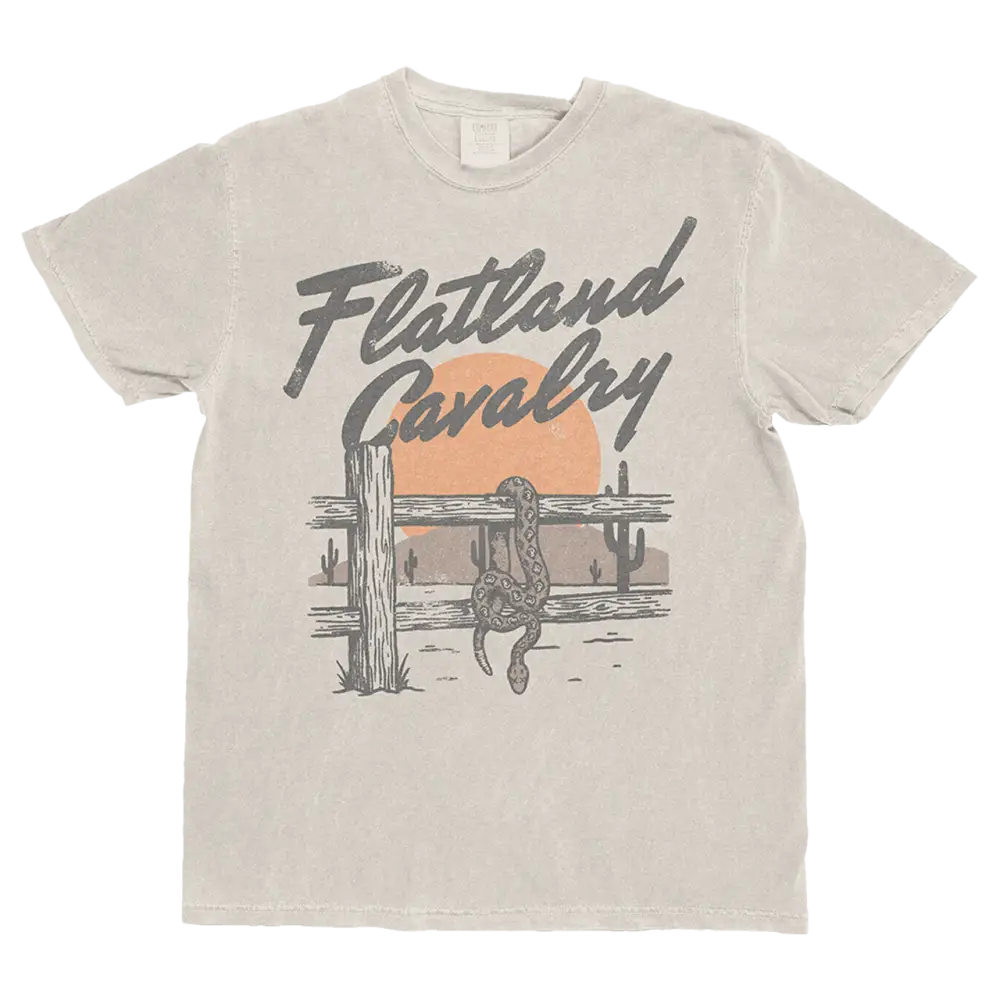 Beige cotton t-shirt featuring a vintage-style graphic of a snake coiled around a fence with cacti and an orange sun, printed in gray ink.