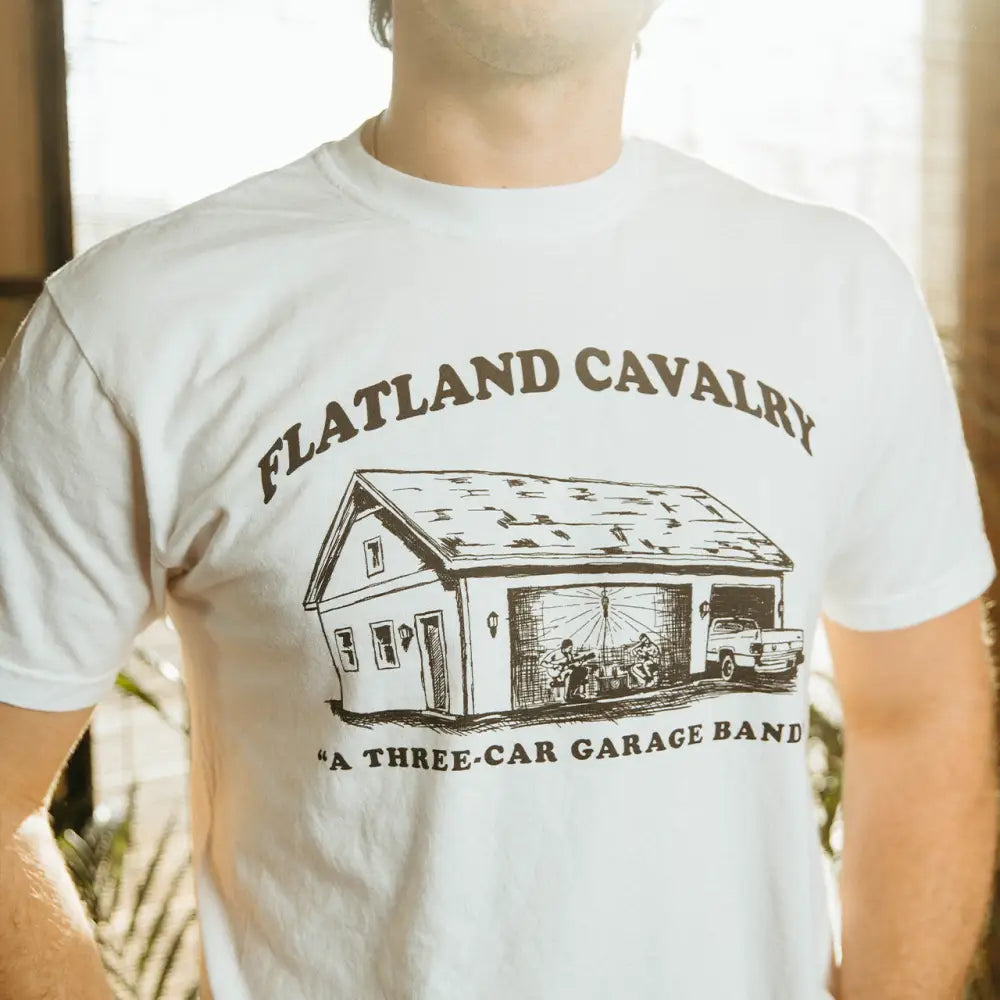 White t-shirt with garage band graphic.