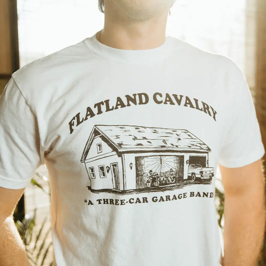 White t-shirt with garage band graphic.
