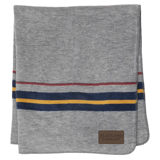 Gray blanket or throw with colorful striped accents and a leather patch.